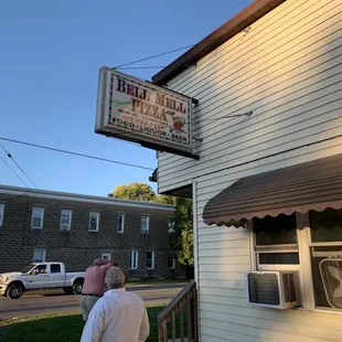 a man standing outside of a restaurant