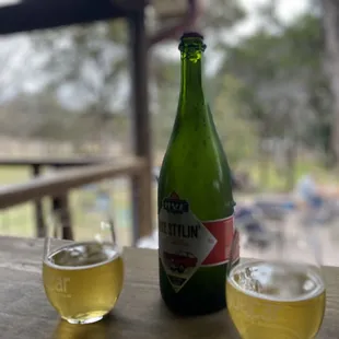 a bottle of beer and two glasses of beer