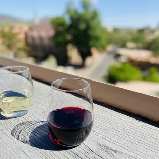 two glasses of wine on a balcony
