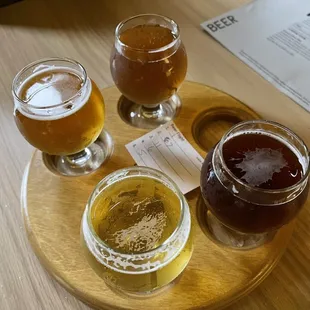 a variety of beers on a tray