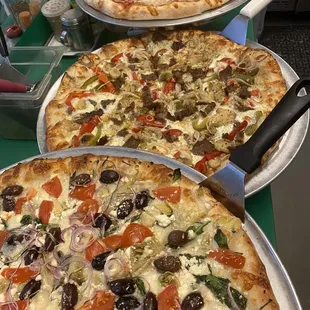three pizzas on a table