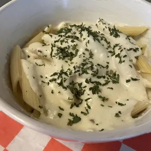 a bowl of pasta with cheese and herbs