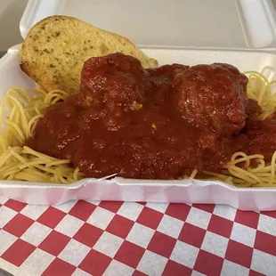 a container of spaghetti and meatballs