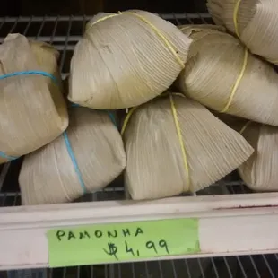 Pamonha.. Some sort of Brazilian tamale described to me as creamy corn. String colors tell you if it has cheese and or sausage