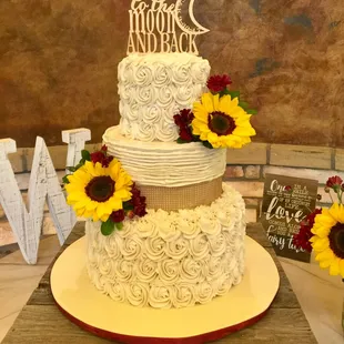a wedding cake with sunflowers