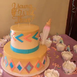 a cake and cupcakes on a table