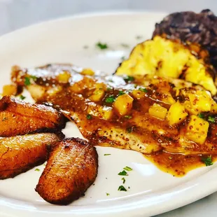 Tropical Chicken served on Grilled Pineapple with our Black Bean Rice and Sweet Fried Plantains