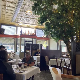 people sitting at tables in a restaurant
