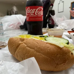 a hot dog with pickles and cucumbers