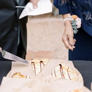 a person cutting a pizza