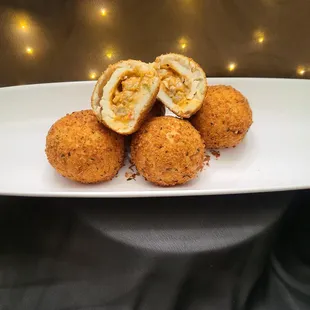 Crawfish Potato Balls. Mashed potato ball filled with Bella Flans Spicy Crawfish Etouffee covered in a crispy Panko crust.