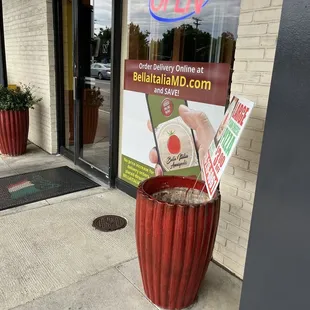 a red planter outside a restaurant