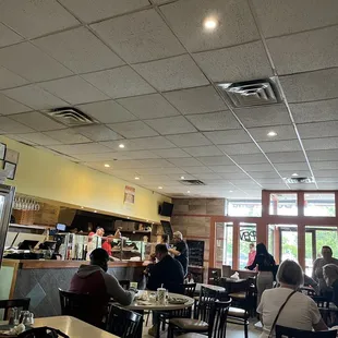 people sitting at tables in a restaurant