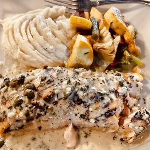 Grilled salmon with a lemon caper sauce. Melt in your mouth!