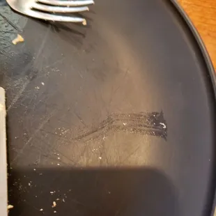 a fork and knife on a black plate