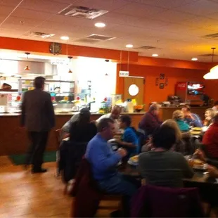 people sitting at tables in a restaurant