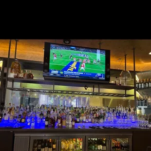 a bar with a large screen tv