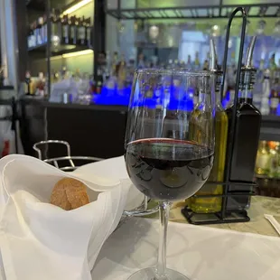 a glass of wine and bread on a table