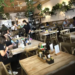 people sitting at tables in a restaurant