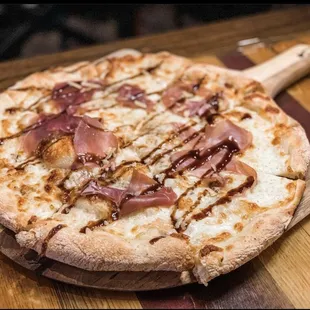 a pizza on a wooden board