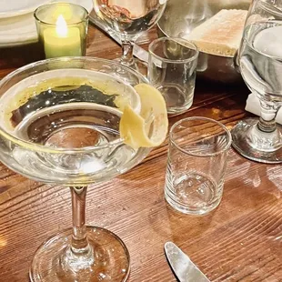 a table with a pizza and glasses of water