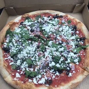 This is the La Greca. Thin crust with black olives, onions, spinach, sauce, and olive oil.
