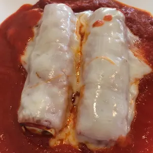 two enchillas covered in sauce