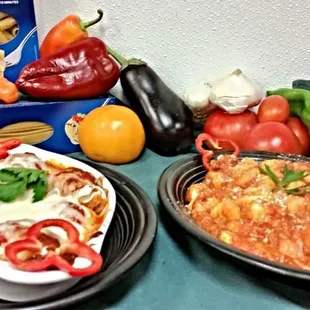 two plates of pasta and vegetables