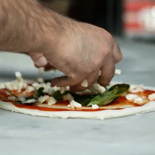 a person making a pizza