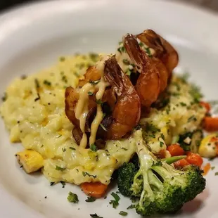 Bacon wrapped prawns over saffron risotto