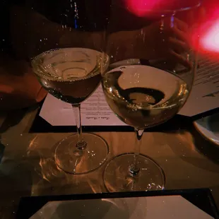 two glasses of wine on a table