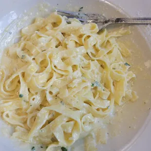 a plate of pasta with a fork