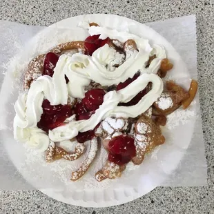 Tey our Awesome Funnel Cake with strawberry topping and whip cream!