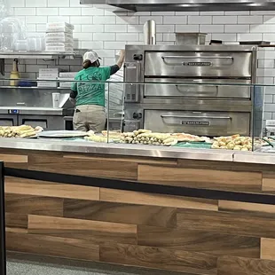 a woman preparing food in a kitchen