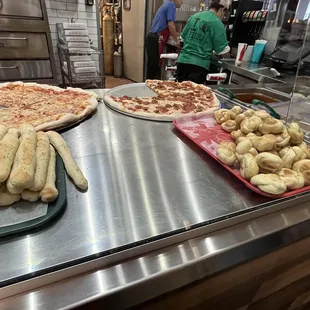 a variety of pizzas on display