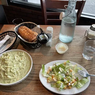 a plate of salad and a bowl of mashed potatoes