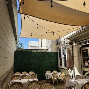 an outdoor dining area with tables and chairs