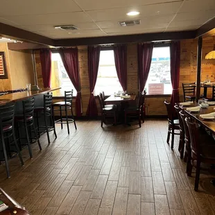 a restaurant with wood floors and tables