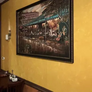 a restaurant with a painting on the wall