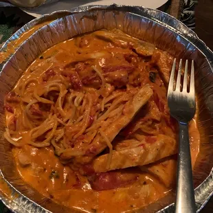 a plate of spaghetti and meat