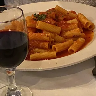 a plate of pasta and a glass of wine