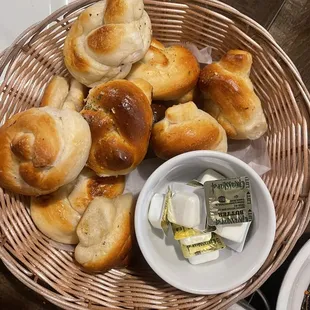 a basket of bread rolls and butter