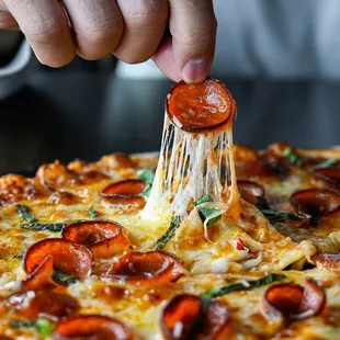 a person dipping a slice of pizza