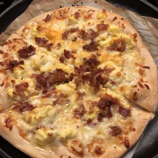 a pizza with cheese and bacon