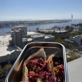 a person holding a container of food