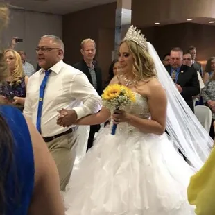 Father of the bride walking her down the aisle