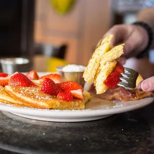 a plate of pancakes and strawberries