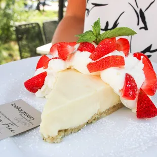 a slice of cheesecake with strawberries