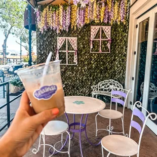 a hand holding a cup of coffee