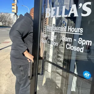 a man leaning against a glass door